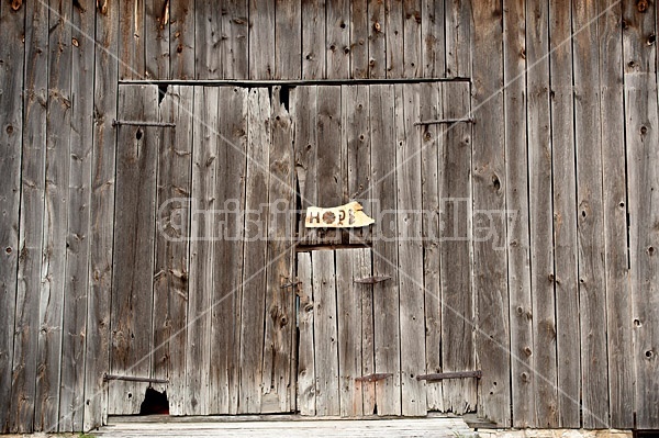 Hand made Hope garden art sign hanging on a barn wall