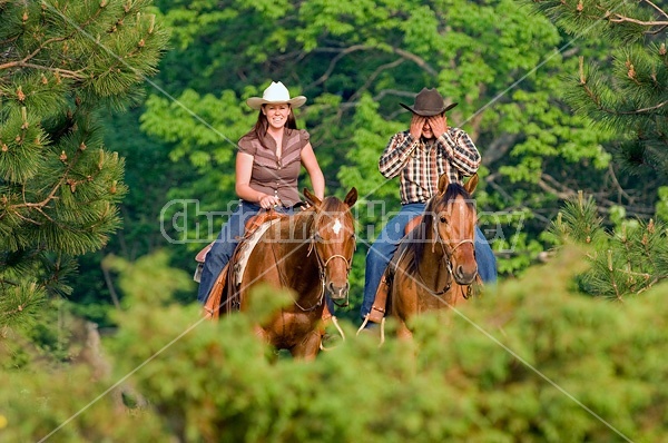 Young couple horseback riding