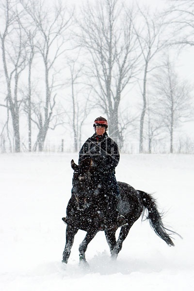 Woman horseback riding in the winter