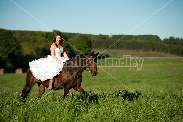 Woman riding horse wearing a wedding dress