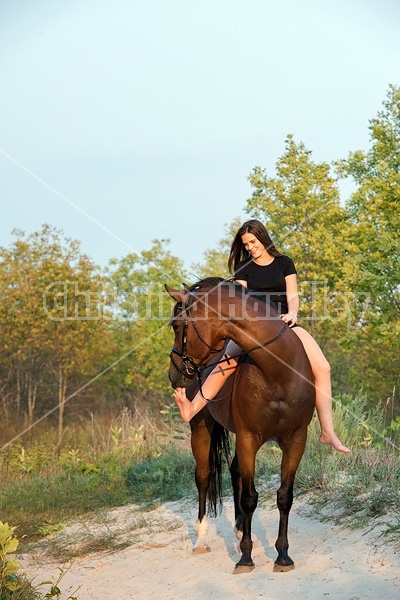 Young woman horseback riding bareback