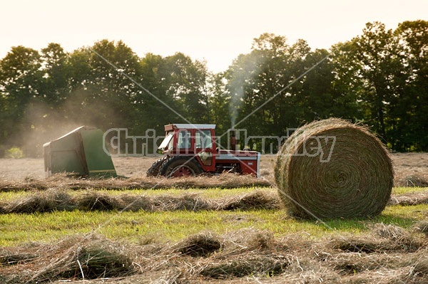 Farmer round baling hay