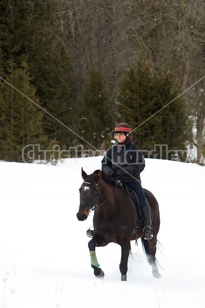 Woman horseback riding in the winter