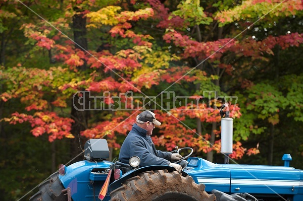 Farmer driving tractor