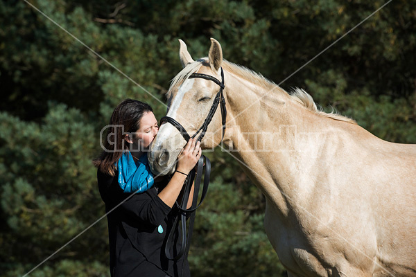 Woman with a palomino horse