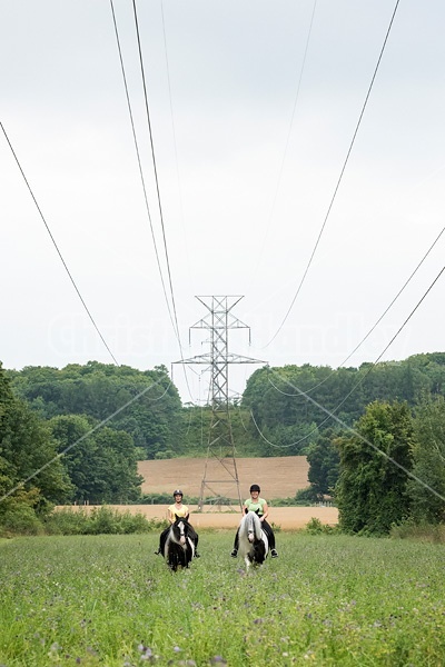 Two women riding Gypsy Vanner horses