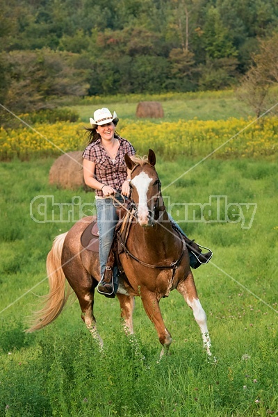 Young woman horseback riding western 