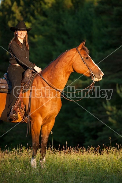 Young woman riding her American Paint horse mare