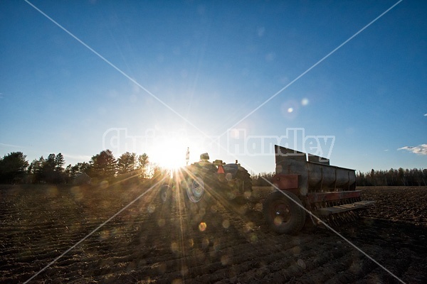 Farmer filling up a seed drill with seed oats.