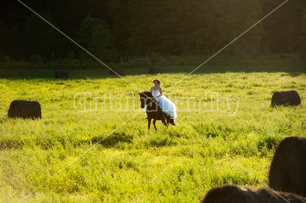 Woman riding horse wearing a wedding dress