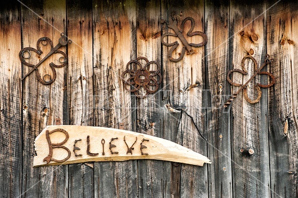 Hand crafted garden art sign made out of wood and recycled or repurposed farm tools and machinery parts