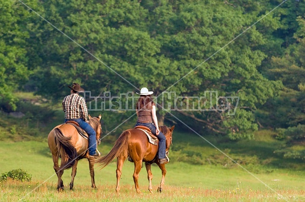 Young couple horseback riding