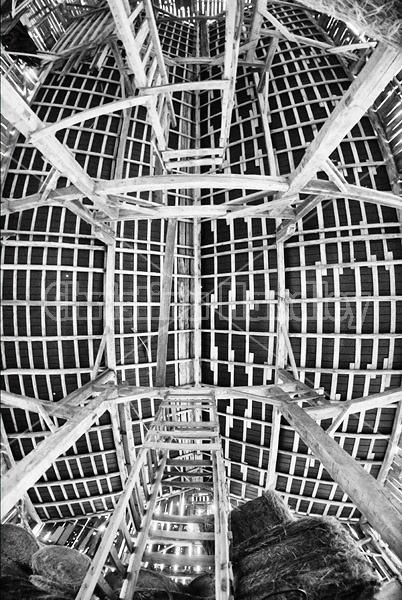 Looking straight up at the ceiling and rafters of the hayloft in an old style barn