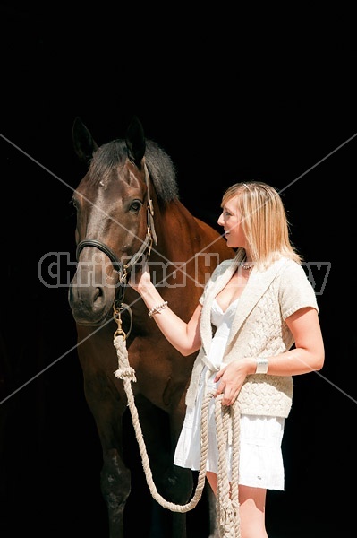 Young woman with her dark bay horse