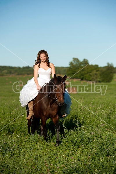 Woman riding horse wearing a wedding dress