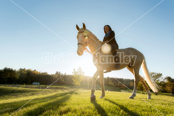 Woman riding a palomino horse