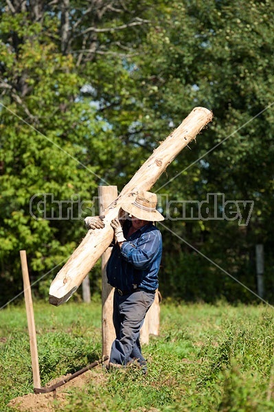 Farmer building new fence