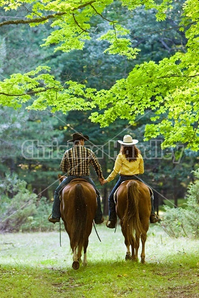 Husband and Wife Trail Riding Together