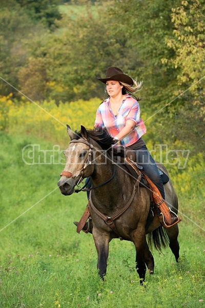 Young woman horseback riding western 