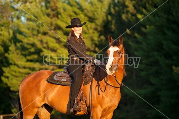 Young woman riding her American Paint horse mare