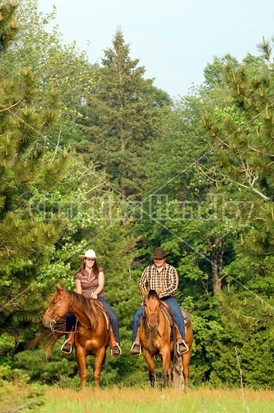 Young couple horseback riding