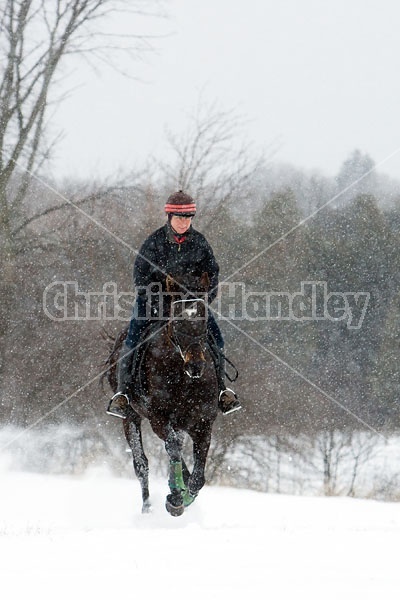 Woman horseback riding in the winter