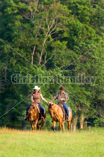 Young couple horseback riding