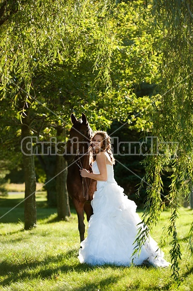 Woman in wedding dress with horse.