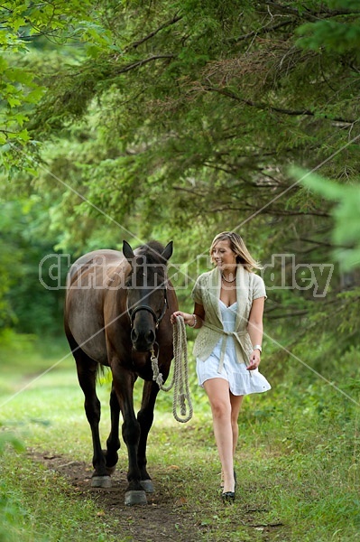 Young woman with her dark bay horse