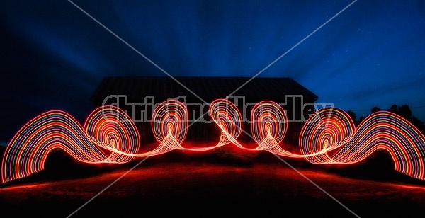 Light painting at night in front of big barn