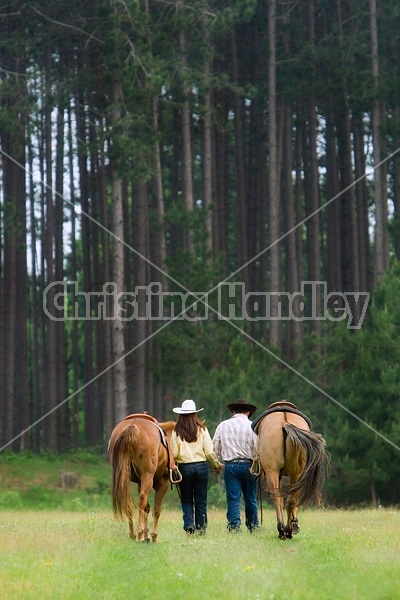 Young couple with their horses 