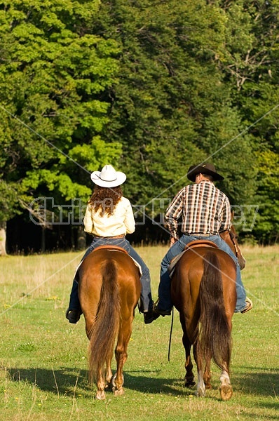 Husband and Wife Trail Riding Together