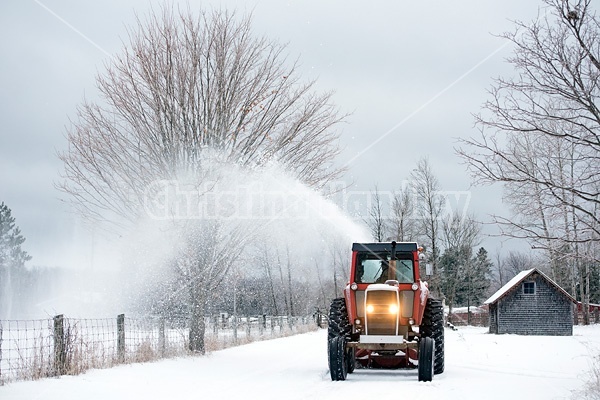 Farmer blowing snow out of driveway