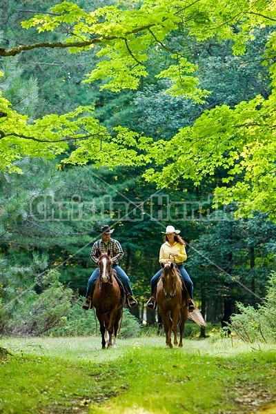 Husband and Wife Trail Riding Together