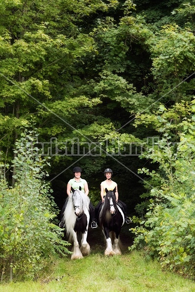 Two women riding Gypsy Vanner horses