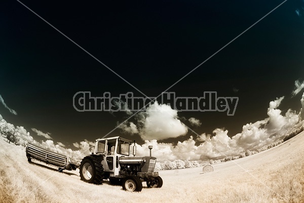 Infrared photo of tractor and haybine cutting hay