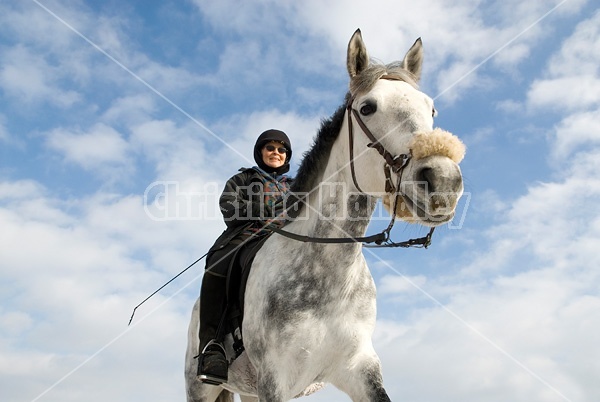 Woman horseback riding in the winter