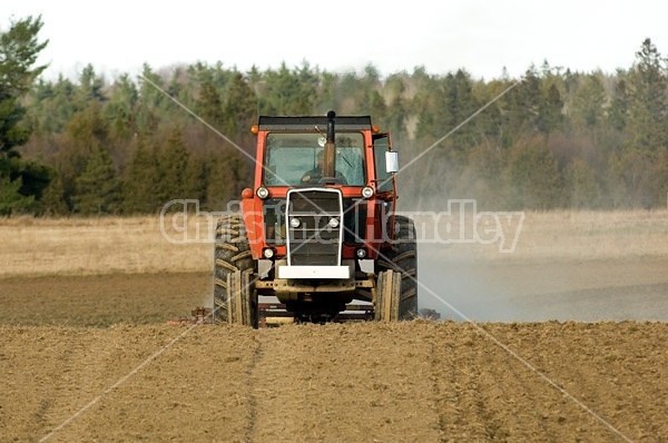 Farmer working a field in the springtime