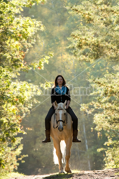 Woman riding a palomino horse