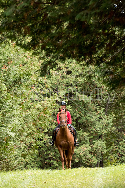 Portrait of young girl horseback riding