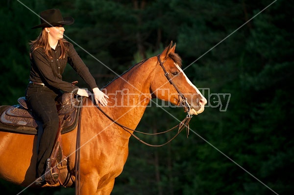 Young woman riding her American Paint horse mare