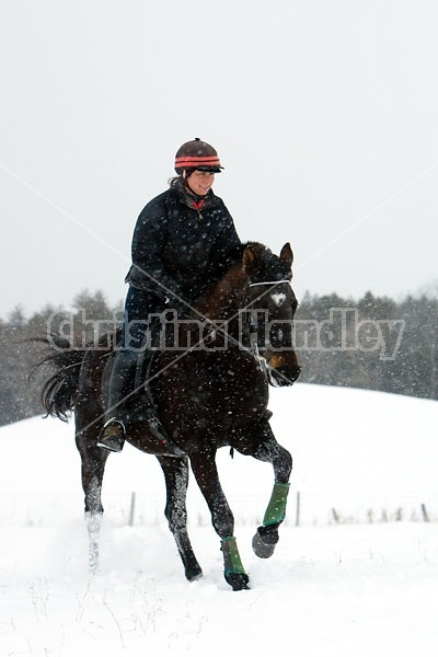 Woman horseback riding in the winter