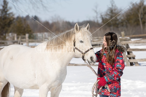 Young girl leading horse