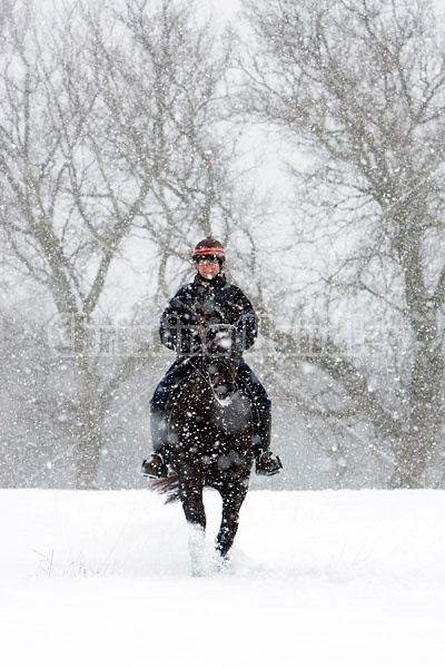 Woman horseback riding in the winter