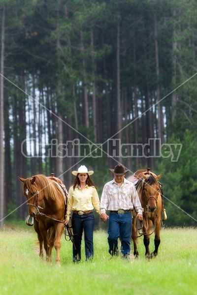 Young couple with their horses 