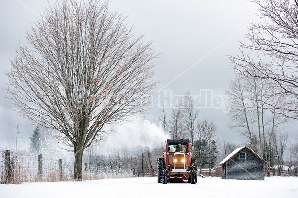 Farmer blowing snow out of driveway