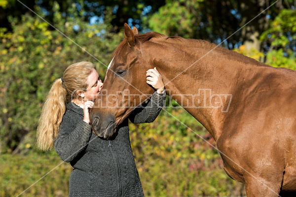 Woman with her Thoroughbred horse