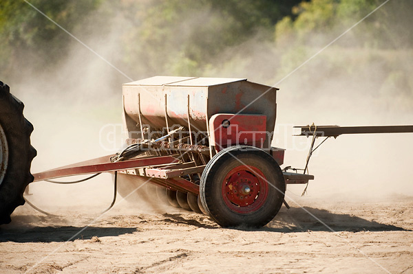 Seed drill being pulled by tractor