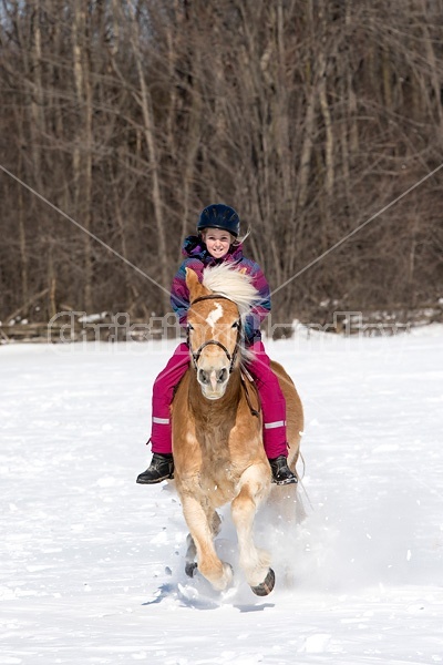 Young girl riding her pony bareback