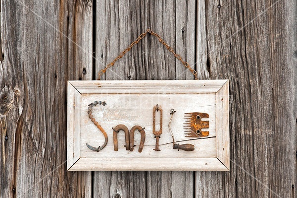 Hand crafted Smile art sign made out of wood and recycled or repurposed farm tools and machinery parts